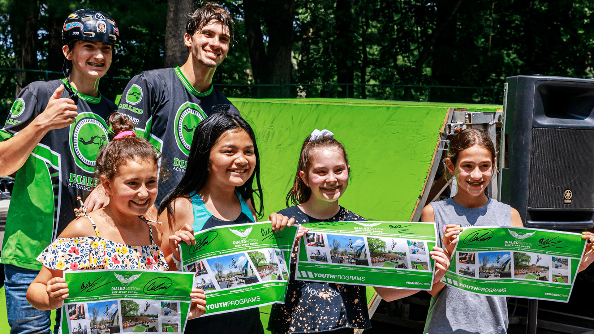 A group of students posing with their free posters following a school assembly in New York State