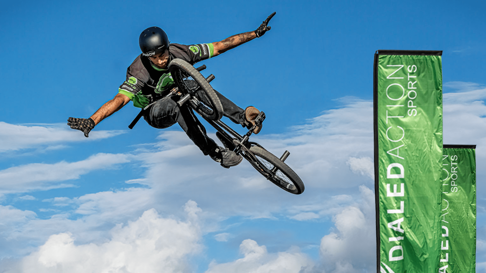 BMX athlete mid-air showcasing a “tuck no-hander 360”