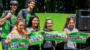 A group of students posing with their free posters following a school assembly in New York State
